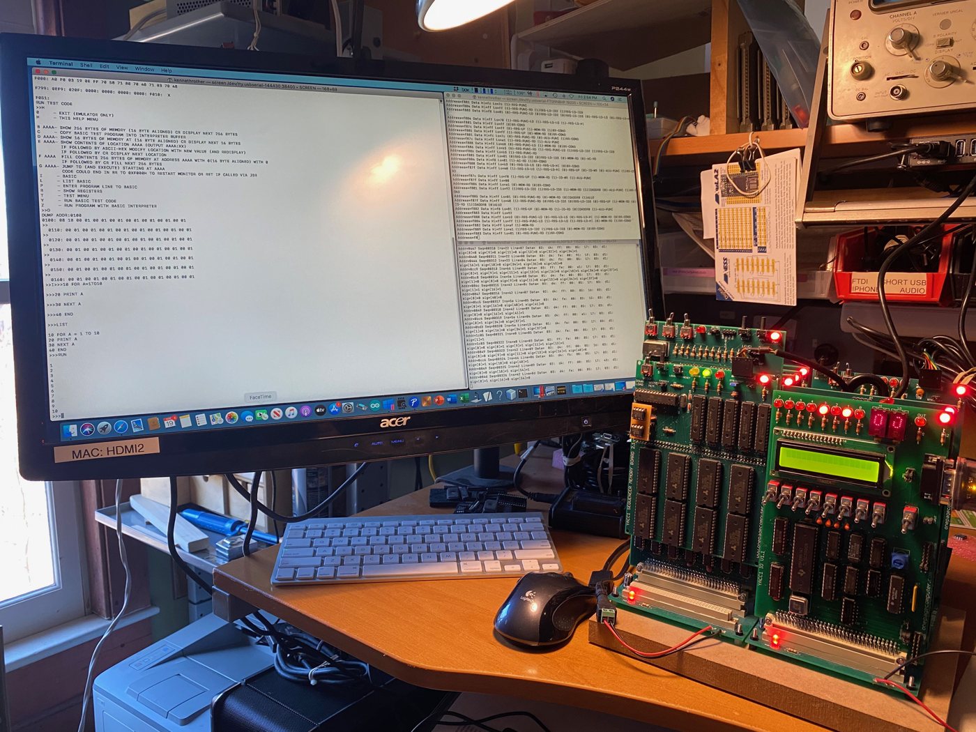 YACC1 on the bench: the cards stacked on the bus, LEDs, hex displays and LCD lit, next to a Mac running a monitor and BASIC session